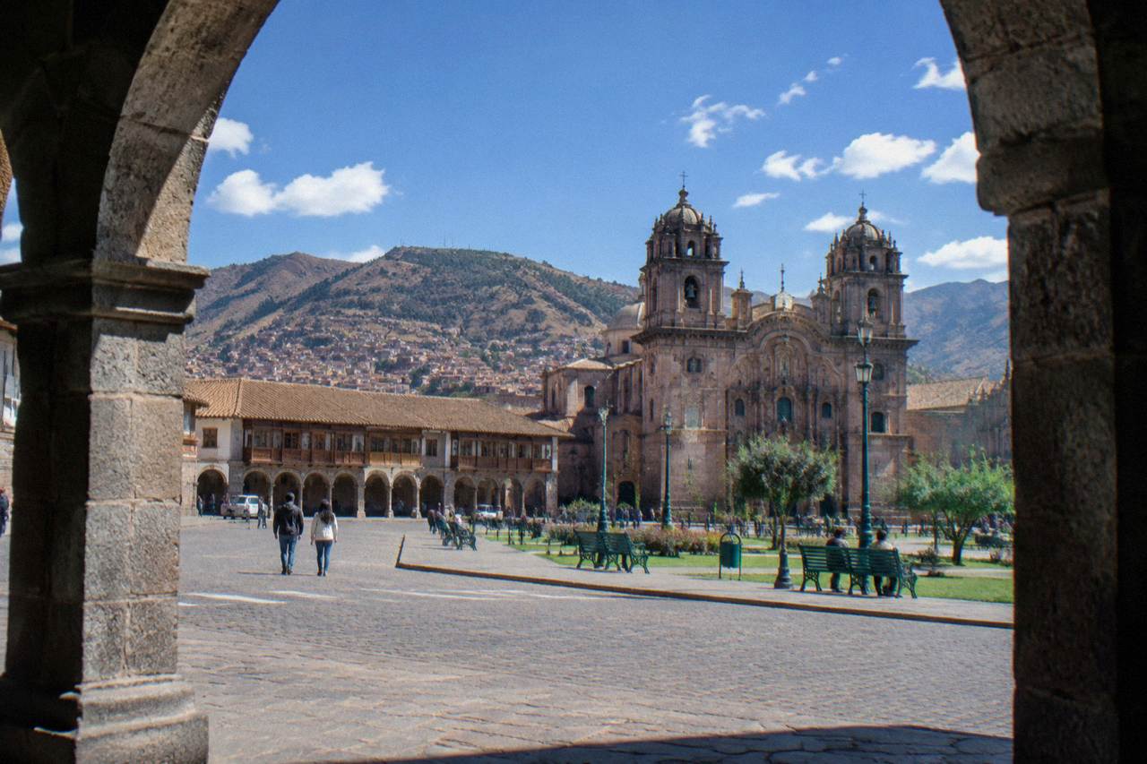 Cusco's Plaza de Armas with colonial arcades and cathedral towers under a clear Andean sky