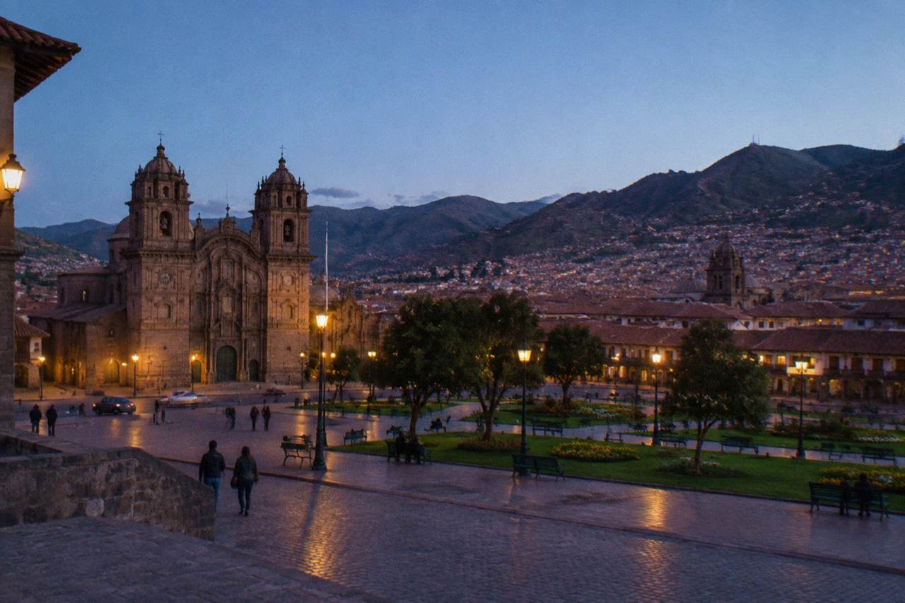 Terracotta rooftops of Cusco spreading across a high Andean valley under a clear sky