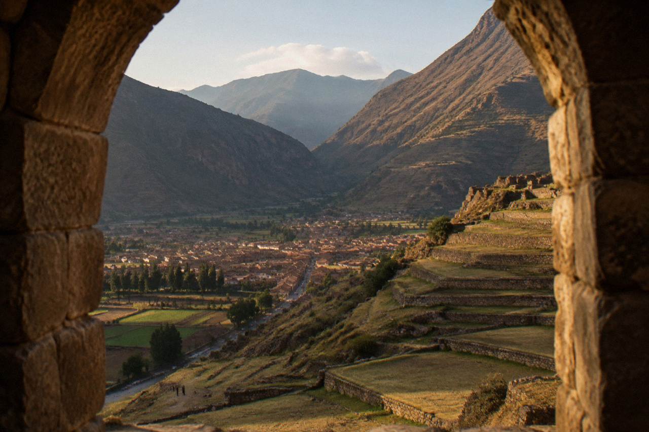 Terraced hillsides above an Andean valley town with fields in the foreground