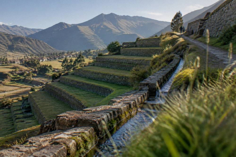 Inca agricultural terraces with stone water channels on a hillside in the South Valley