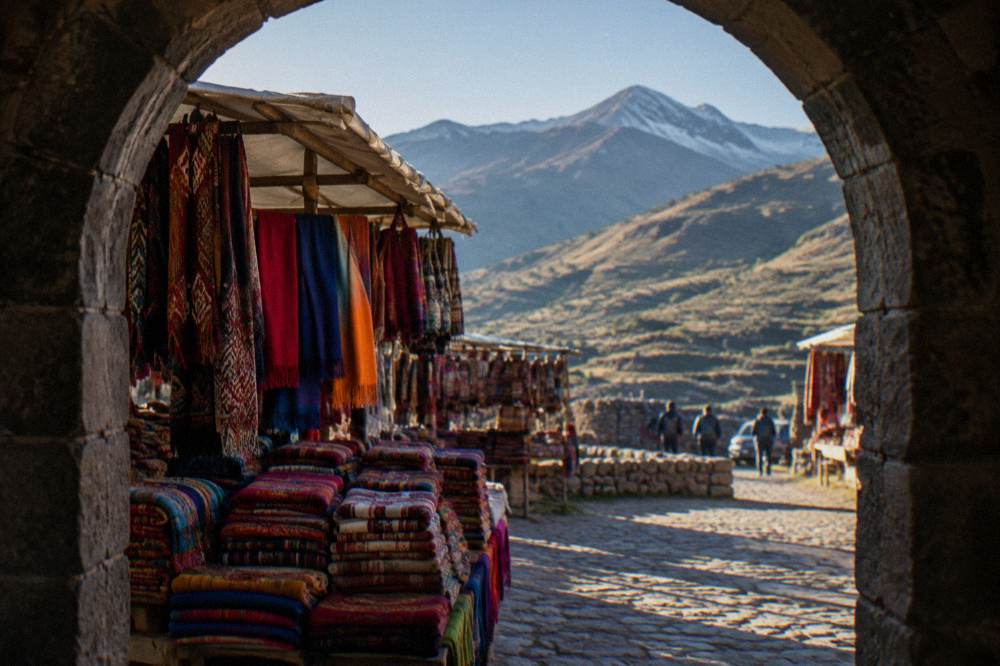 Stacks of brightly coloured woven textiles and scarves on a market stall