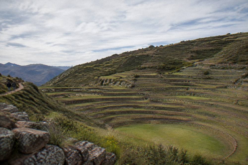 Stone agricultural terraces at Moray under a wide sky