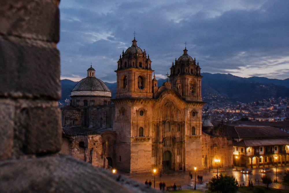 The Cathedral bell towers against an evening sky above the rooftops of Cusco