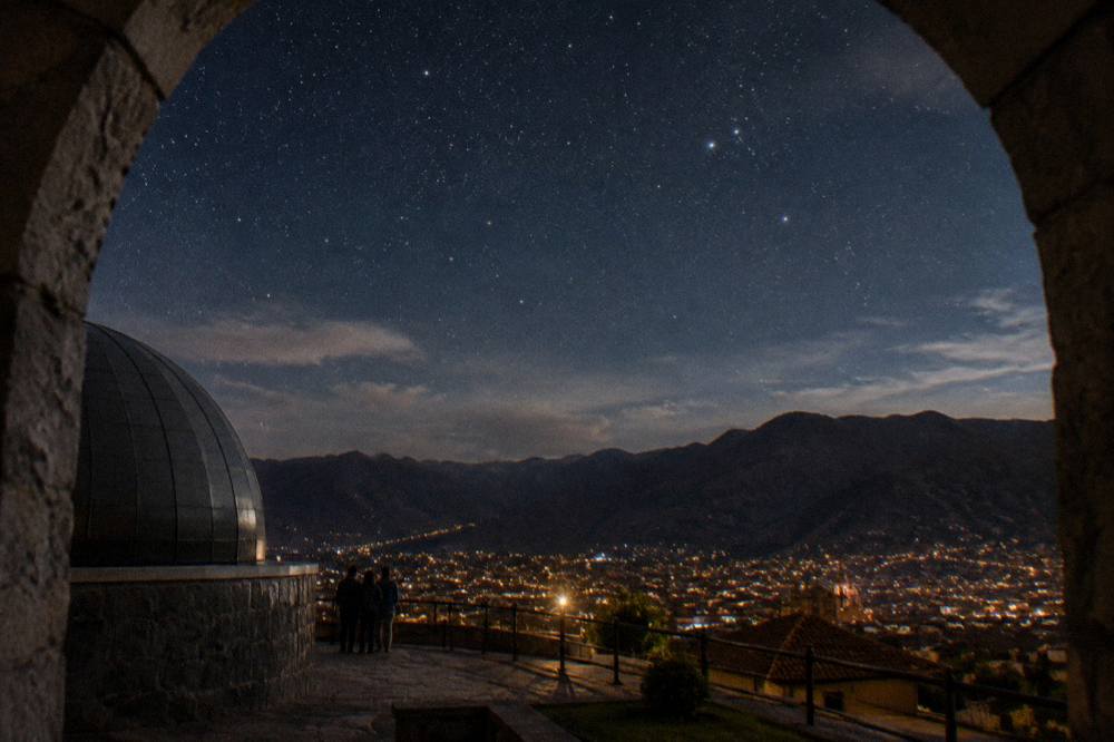 A starry sky over the dark silhouette of Andean ridges above Cusco