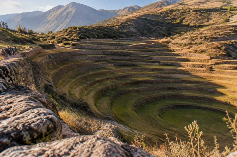 Golden late afternoon light across the circular terraces of Moray with long shadows on the rings