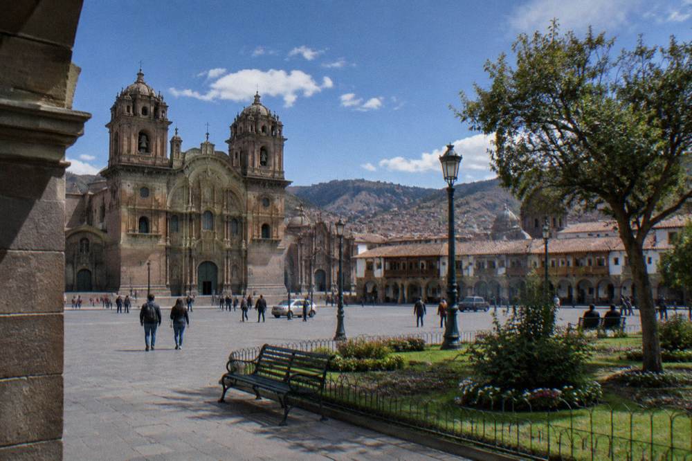 A gallery interior in a Cusco museum with stone arches and display cases