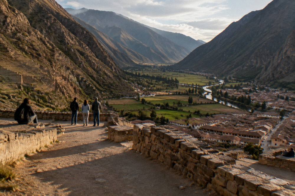 Visitors on a high terrace overlooking the valley floor with river and farmland below