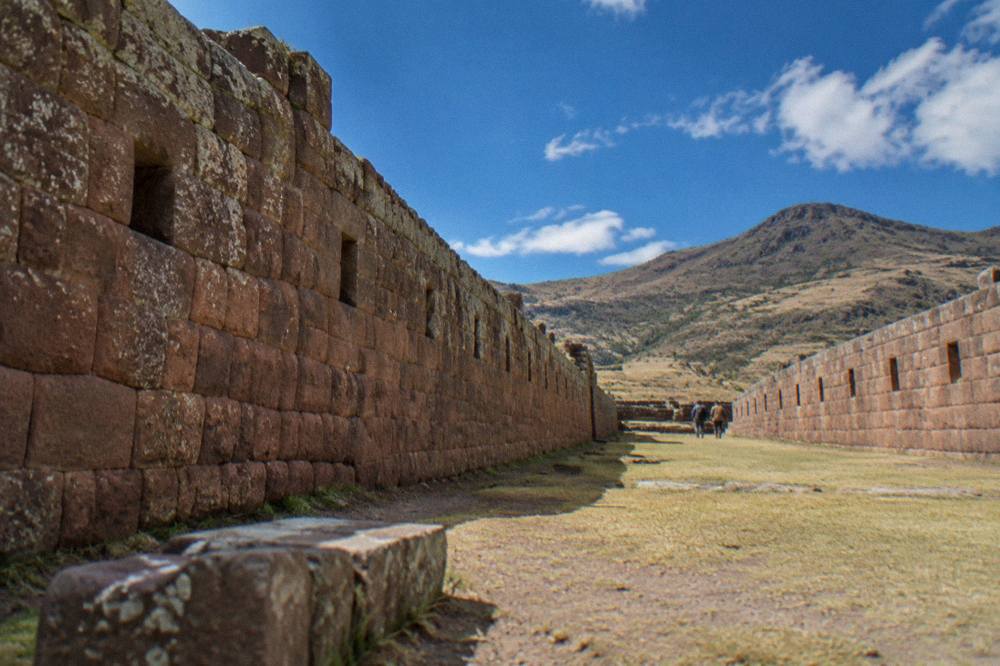 Straight walls receding into the distance inside a large ancient enclosure