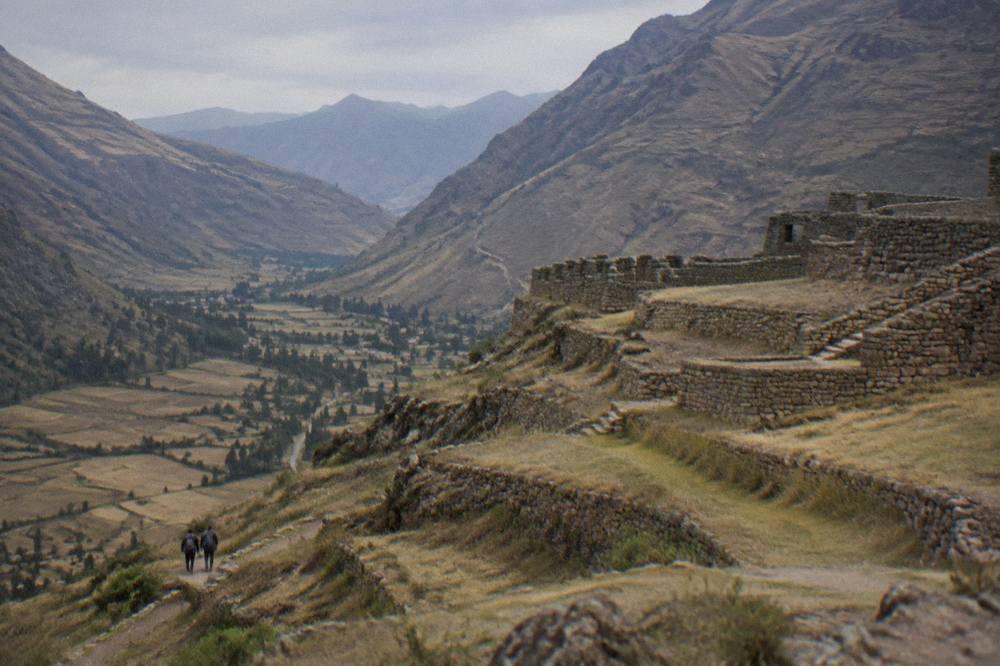 Morning light over a dry Andean valley with terraced hillsides