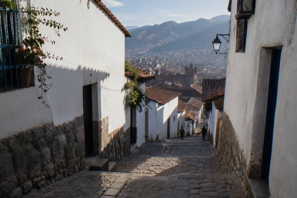 Smoothly fitted Inca stone masonry forming niches and a wall under an open sky