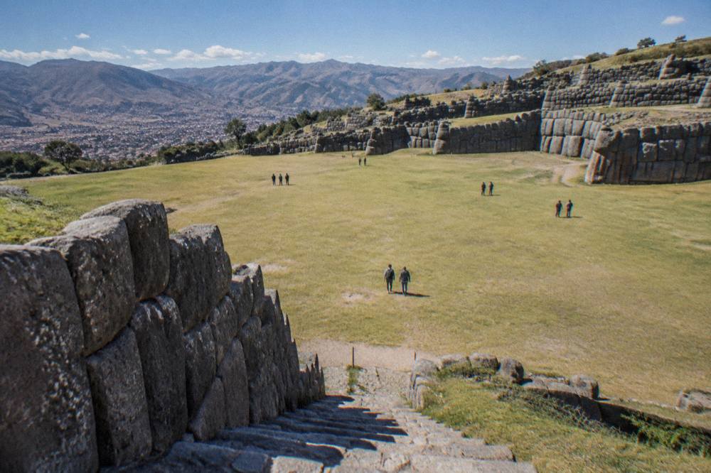 Massive fitted stone blocks forming a long zigzag wall on a hillside