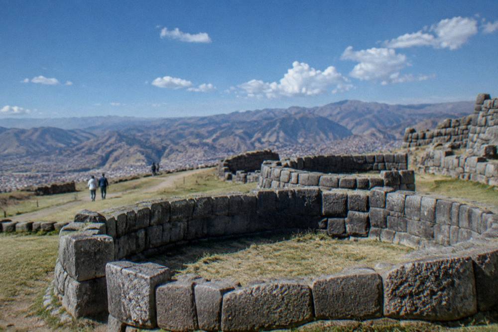 Circular stone foundations on a hilltop with open sky above