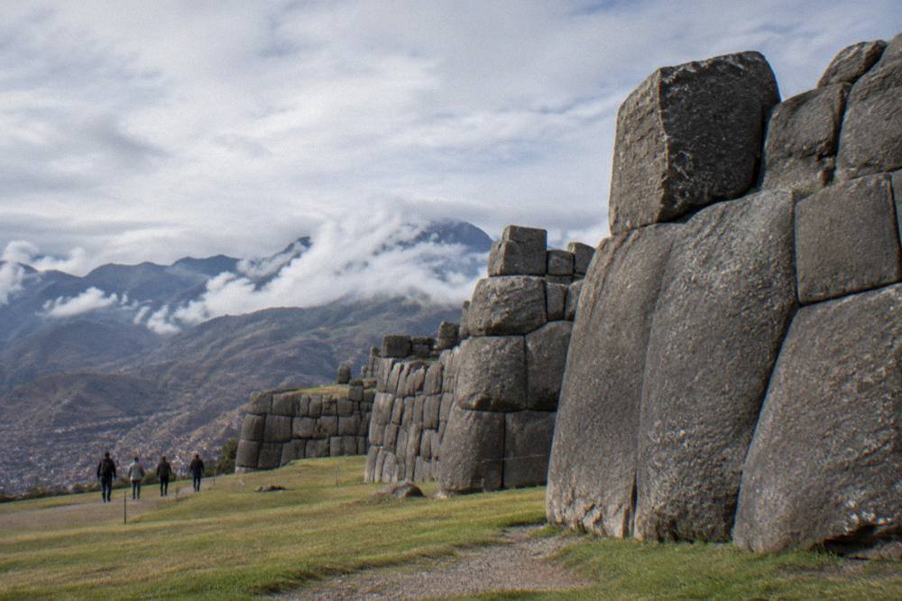 Clouds passing over Andean hills around a high archaeological site on a clear morning