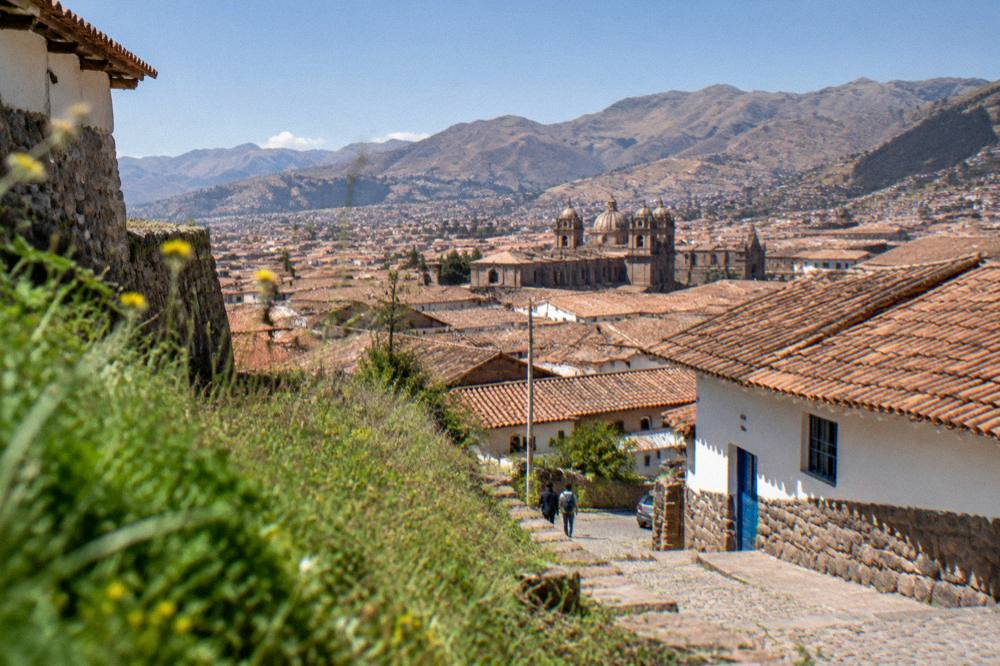 Clear morning light over the red tiled rooftops of central Cusco