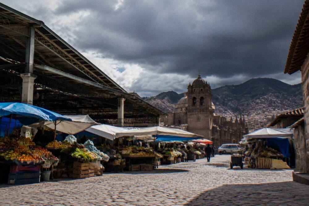 Dark rain clouds gathering over the rooftops of a high Andean city