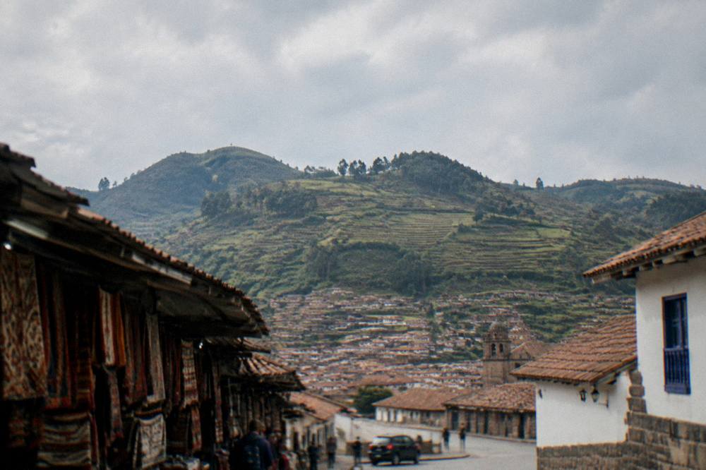 Terraced hills rising above a green valley in the Andes near Cusco