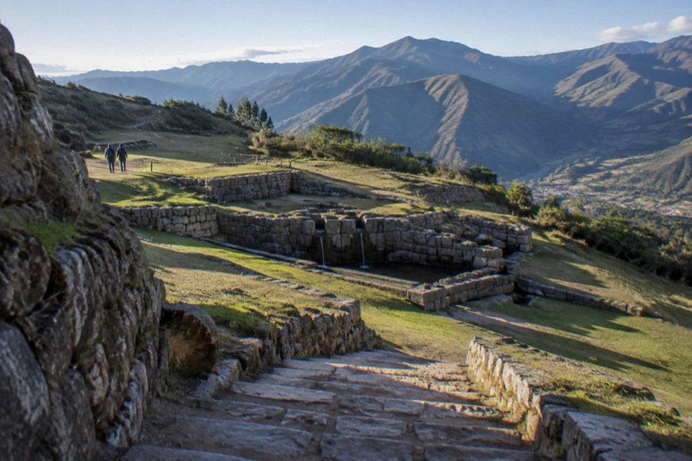 A quiet stone terrace at Tambomachay with the Andes beyond, near Cusco