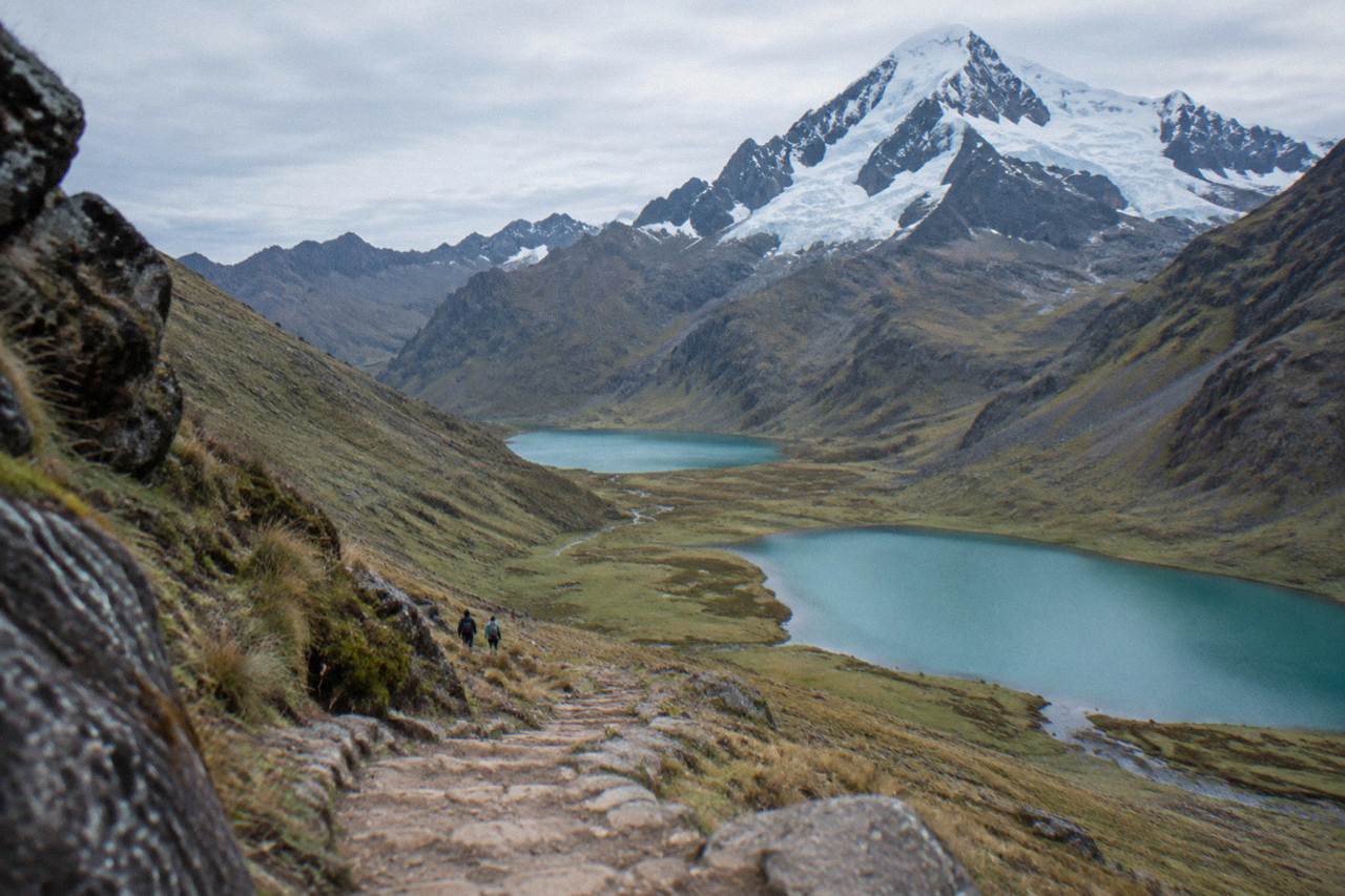 A high Andean valley with turquoise lakes below a snow-capped peak