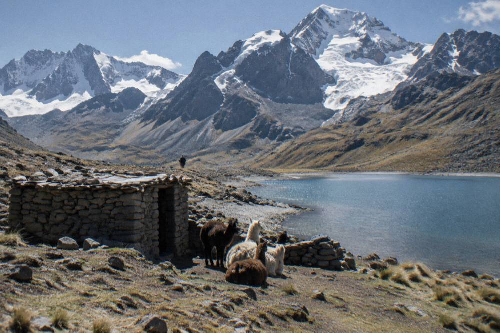 A herder's stone shelter beside a small glacial lake