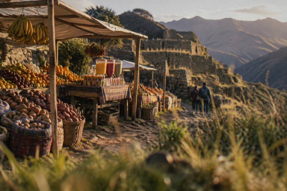 Colourful produce stalls in a Peruvian market with fruit, potatoes and juices on display