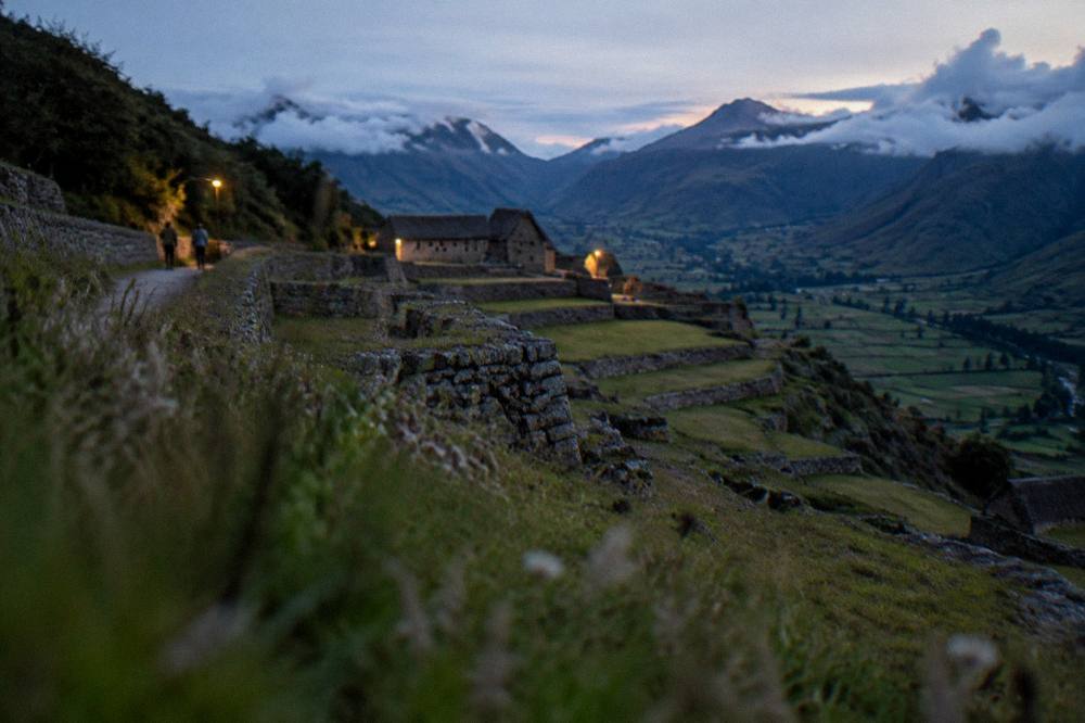 Green Andean valley with agricultural fields and clouds touching the ridgeline