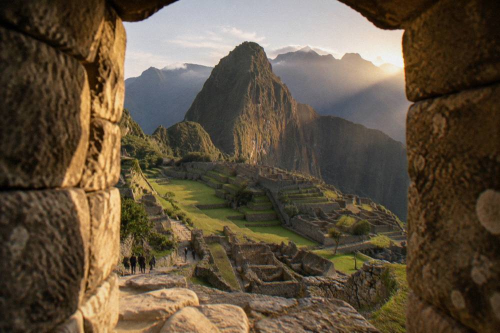 Stone ruins and a grassy terrace at Machu Picchu seen from an upper viewpoint