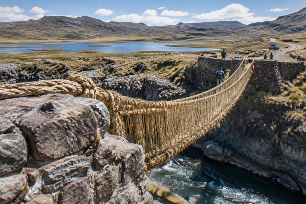 A high Andean plateau with lagoons and dirt roads under a wide sky