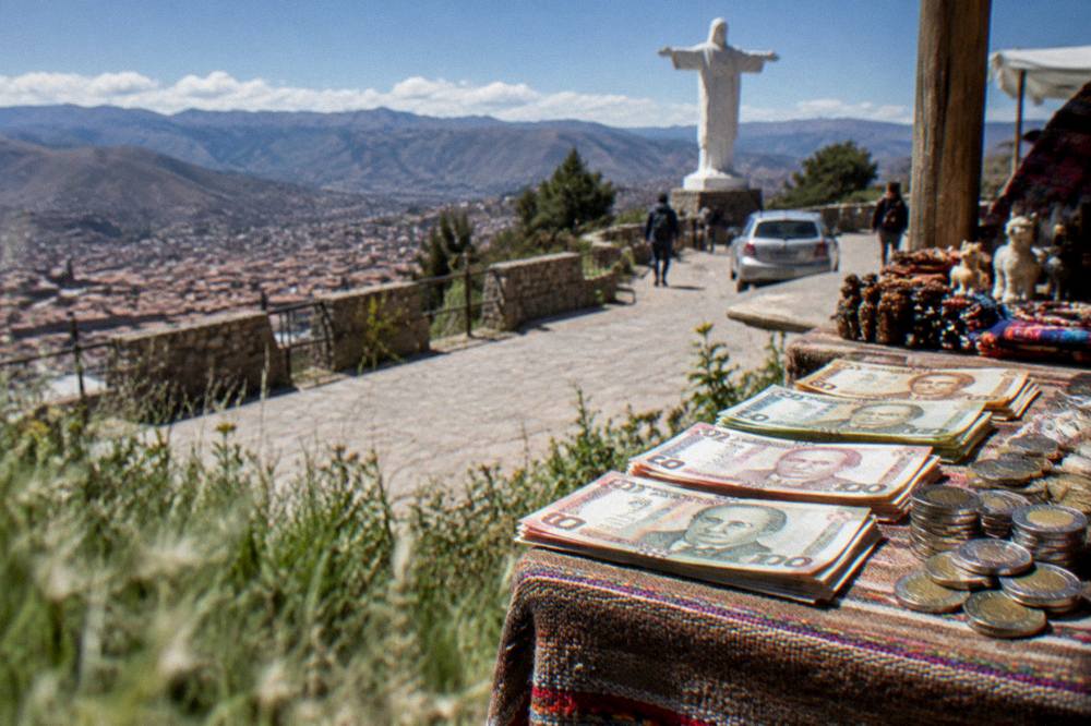 Peruvian sol banknotes and coins on a market stall counter