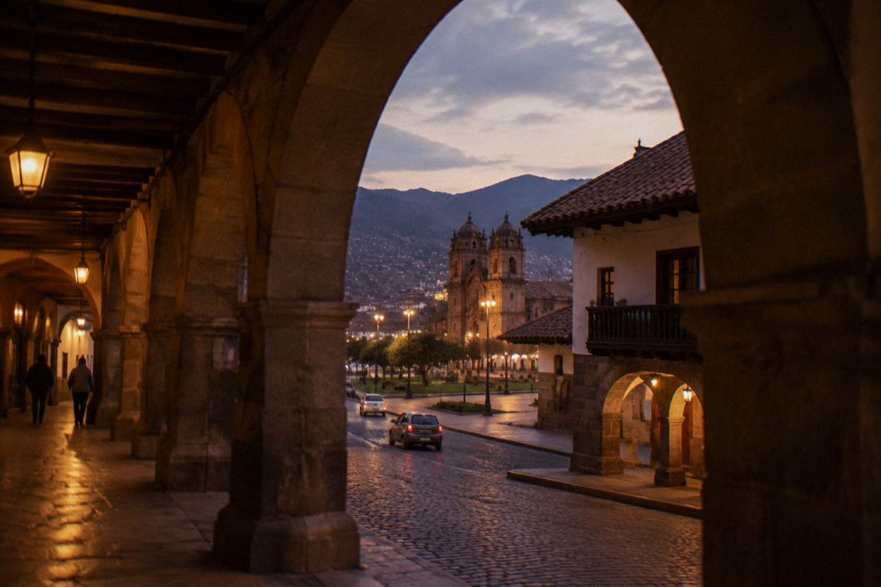 Colonial arcades and tiled roofs around the Plaza de Armas in Cusco at dusk