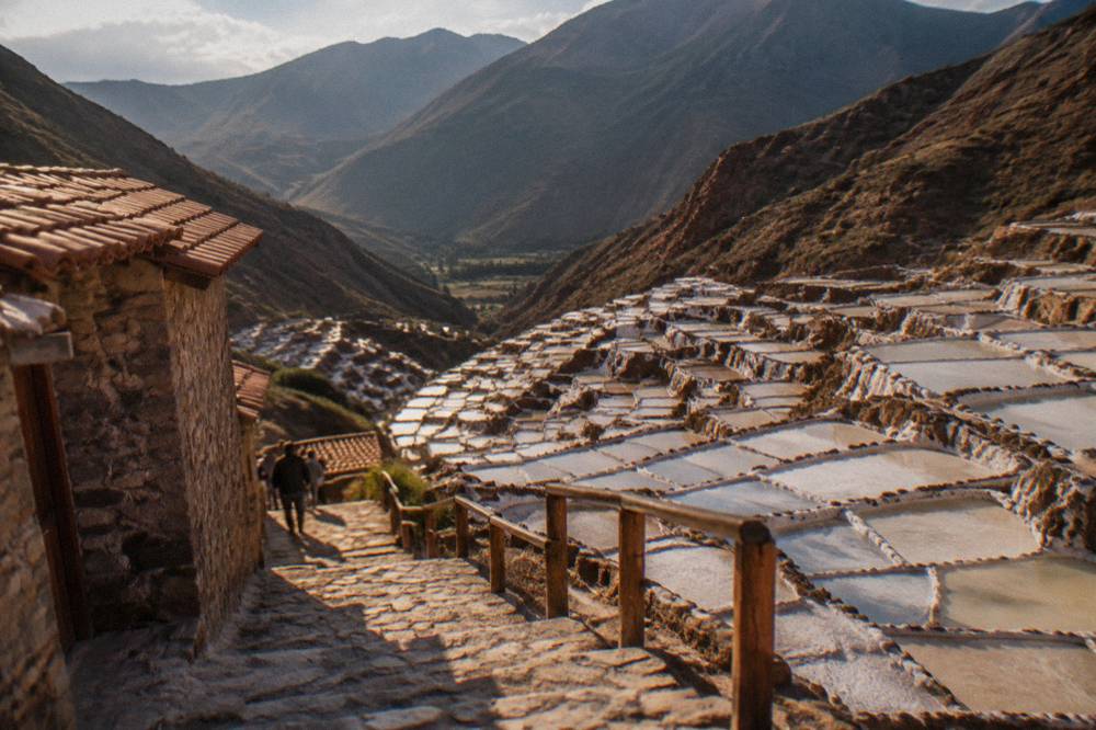White salt evaporation ponds terraced down the hillside at Maras