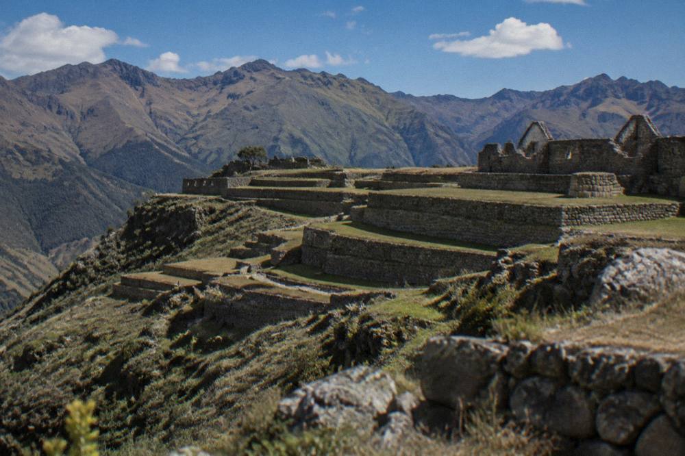 Wide view of a vast Inca terrace complex on a mountain spur with no visible visitors