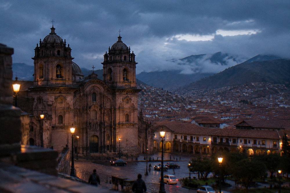 Rain clouds over red-tiled rooftops of a high Andean city