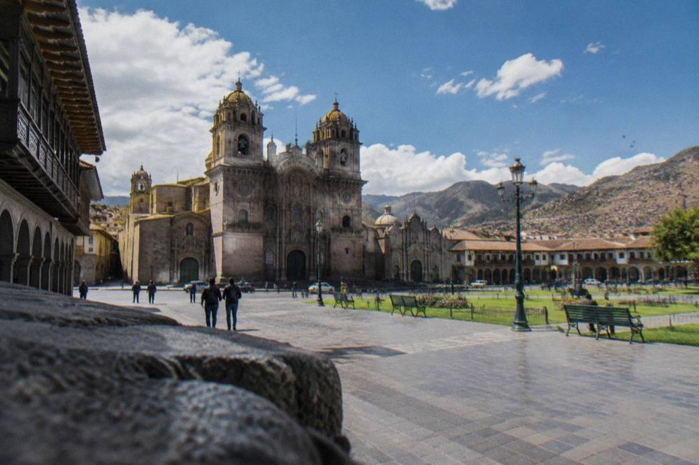 The Plaza de Armas of Cusco with its stone cathedral and arcades under afternoon light