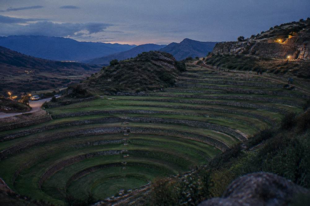Concentric Inca agricultural terraces at Moray curving down into the earth under a wide open sky