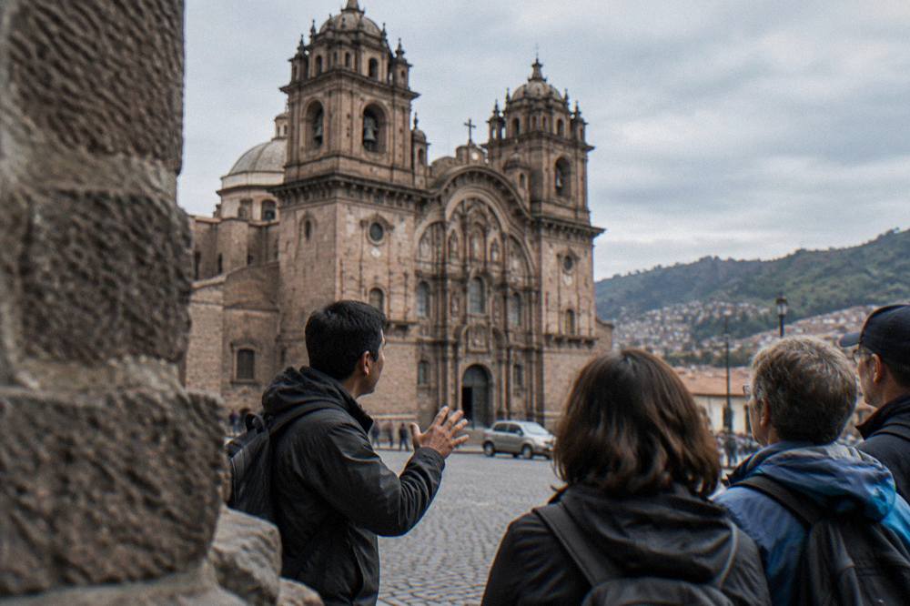A guide speaking to a small group of visitors on a cobblestone street
