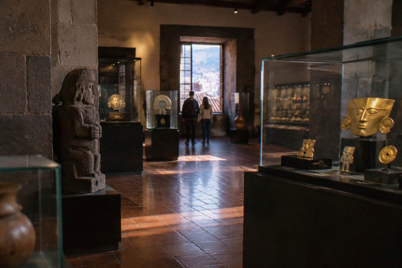 A museum gallery in Cusco with Inca stonework and colonial architecture