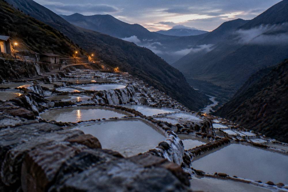 Terraced mountainsides above a river valley with morning mist