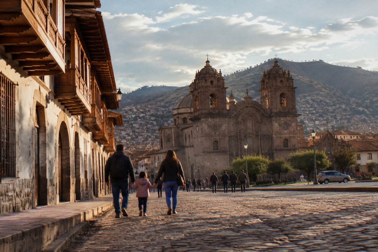A family walking together on a cobbled street of colonial buildings in Cusco