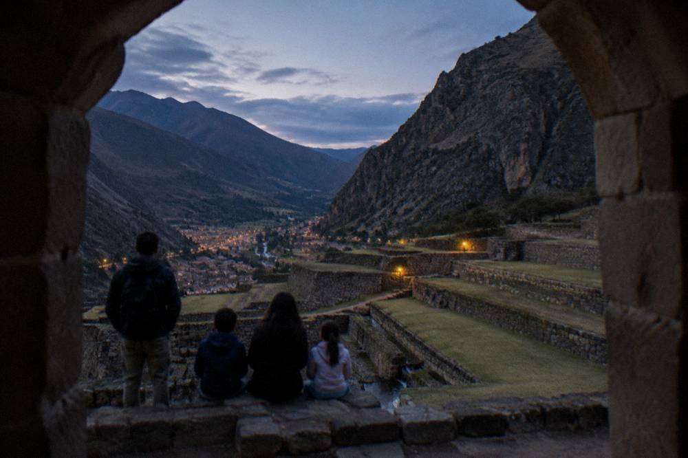 A family looking out over the terraces of Ollantaytambo in the Sacred Valley