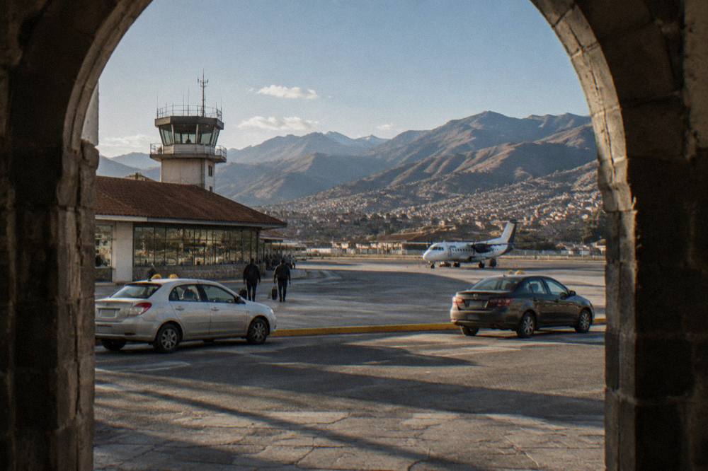 The forecourt of a small high-altitude airport with taxis waiting in daylight