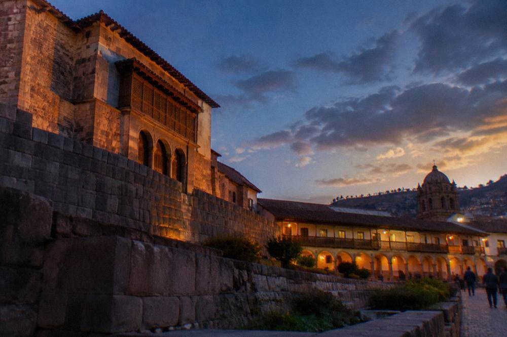 Golden late afternoon light on the arcaded buildings around the Plaza de Armas in Cusco