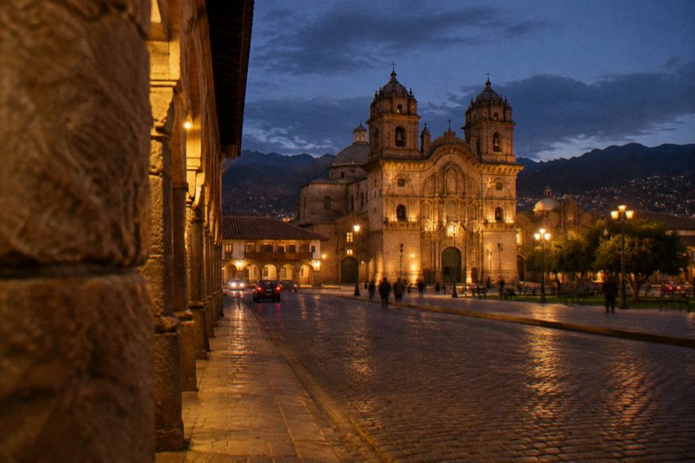 Evening sky over the illuminated colonial cathedral on the Plaza de Armas