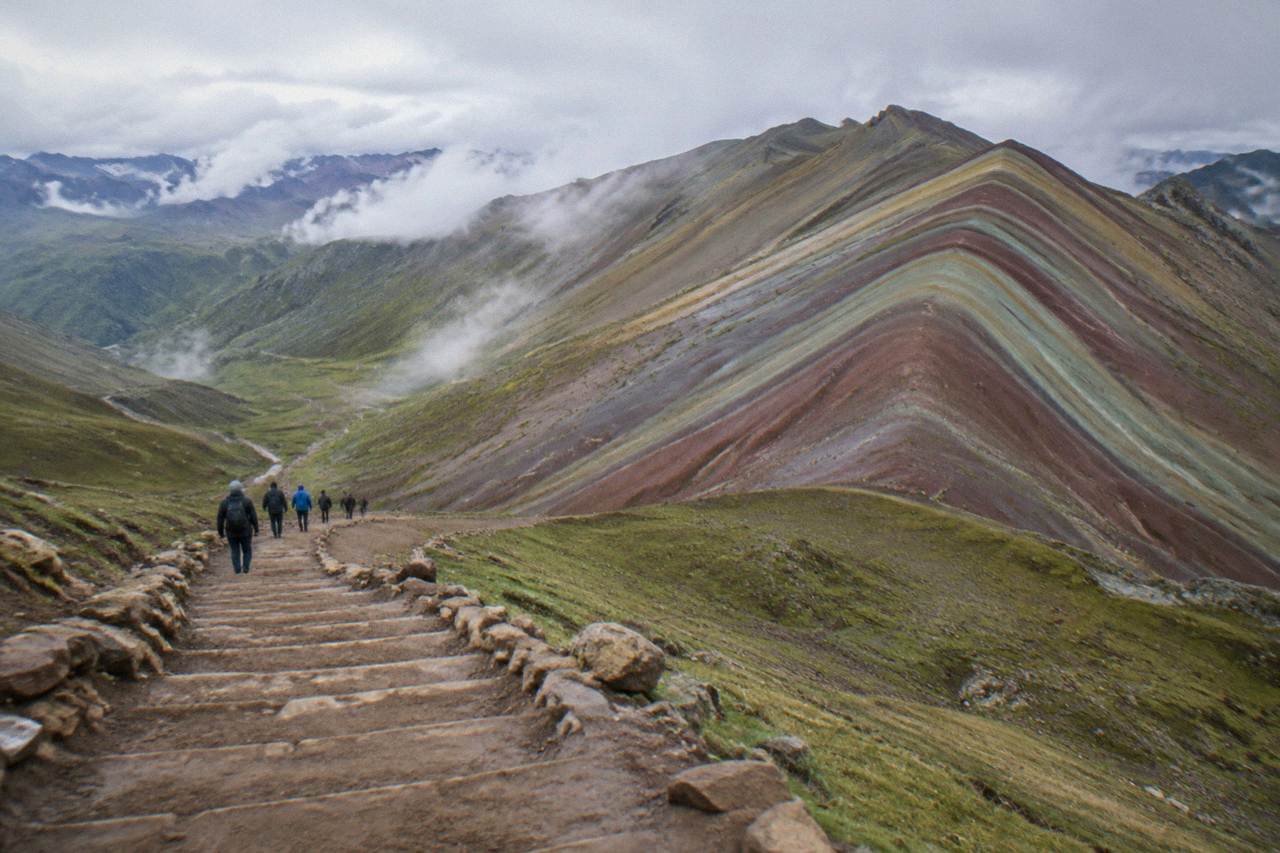Striped mineral slopes of an Andean mountain under a wide sky