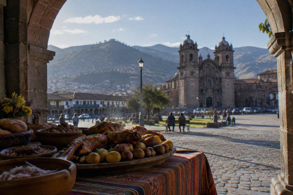 A traditional Andean feast table with roasted meat and potatoes