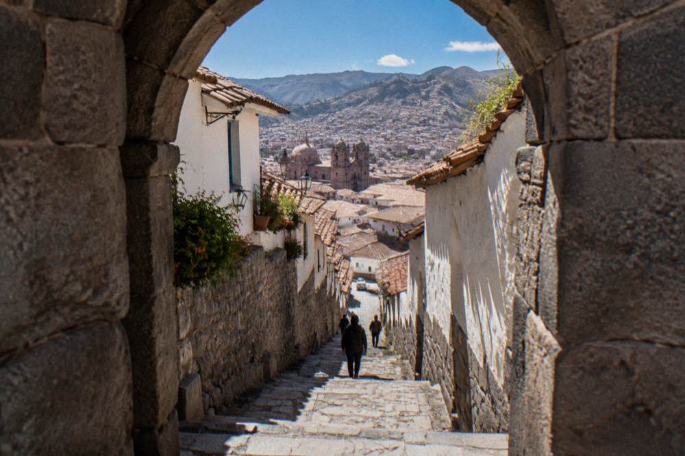 Walking shoes on worn Inca stone steps in Cusco