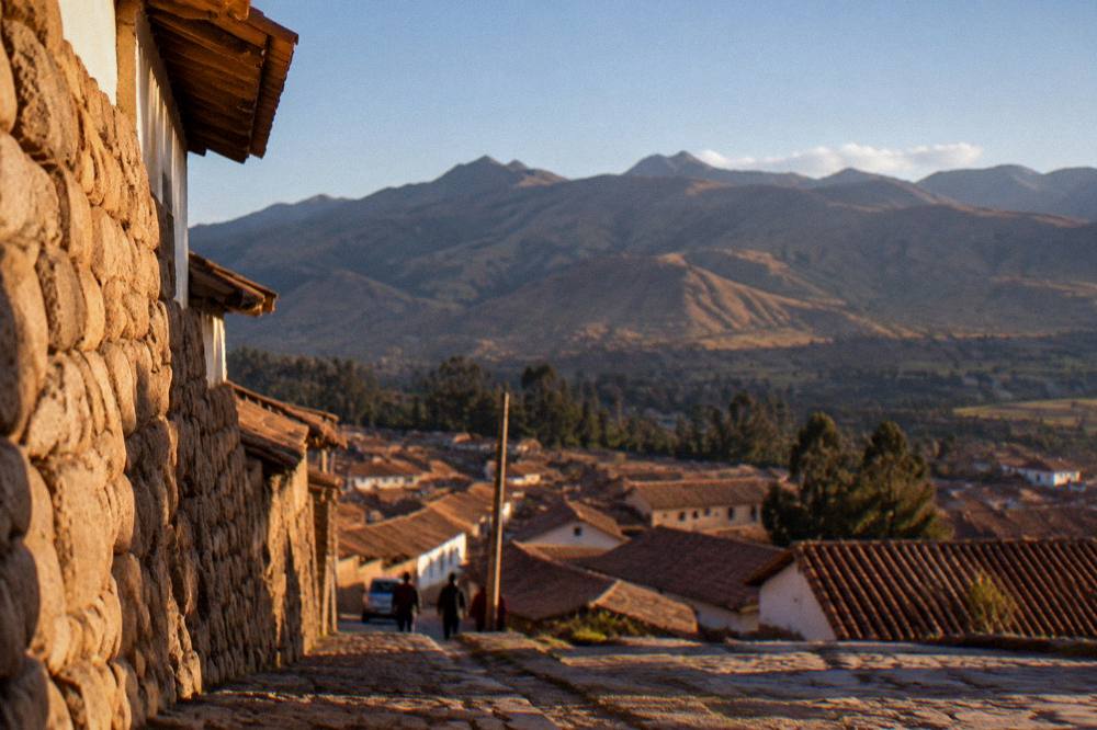 Clear blue sky over terracotta rooftops of a high Andean city