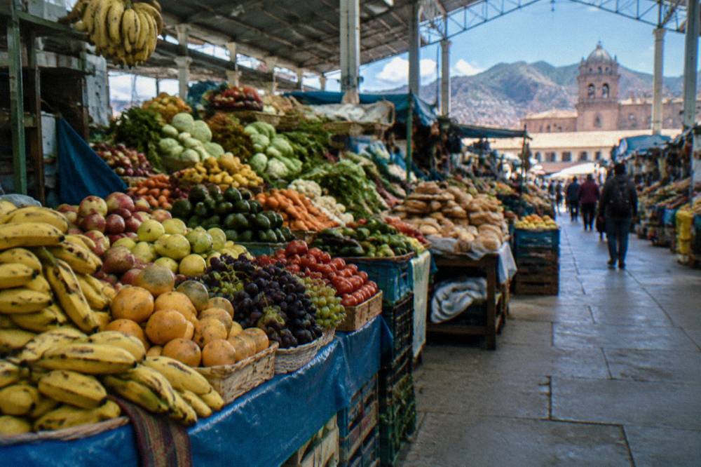 Stalls of fruit, vegetables and bread inside the covered San Pedro Market in Cusco
