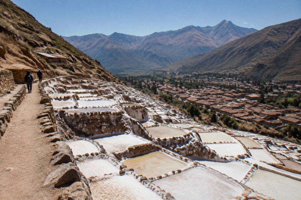 Cusco rooftops under a clear dry-season sky with mountains on the horizon
