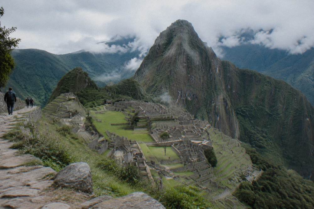 Aerial view of Machu Picchu terraces surrounded by forested mountains