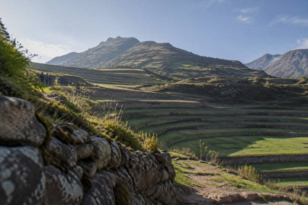 Green Sacred Valley farmland with Inca terraces climbing a mountain slope